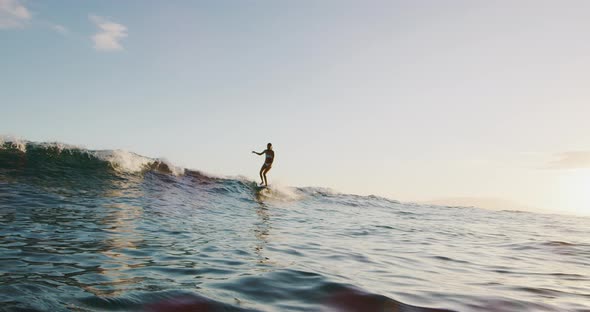 Hanging five surfing at sunset alt