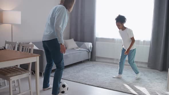 Wellness Father and African Daughter on Selfisolation They Playing with a Soccer Ball in the Living