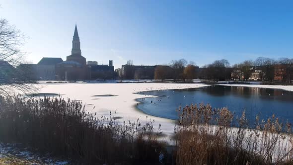 Winter in Kiel. Wide Angle shot of the lake kleiner Kiel in front of the Town Hall. Half frozen lake
