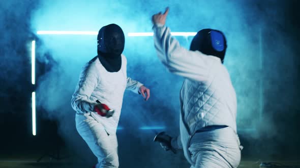 Male Athletes are Having a Fencing Training with Foils