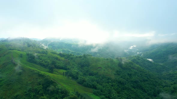 4K Aerial Drone shot flying over beautiful mountain ridge in rural jungle bush forest.