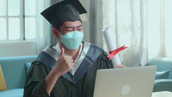 Man Wearing Protection Face Mask, Thumb Up And Showing University Certificate During Video Call