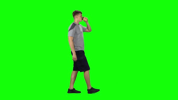 Guy Is Walking and Drinking Disgusting Coffee From a Paper Cup. Chroma Key. Profile Side View
