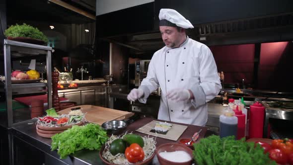 Sushi Chef Making Sushi Rolls With Cucumber, Restaurant Kitchen