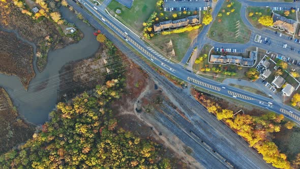 Scenic Aerial View of Autumn Deciduous Tree Forest Near Apartment Complex