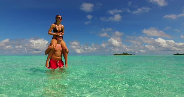 Romantic lady and man on honeymoon vacation enjoy life on beach on sunny white sandy 4K background