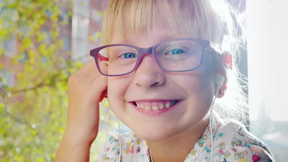 Smiling Girl By the Window in Her House