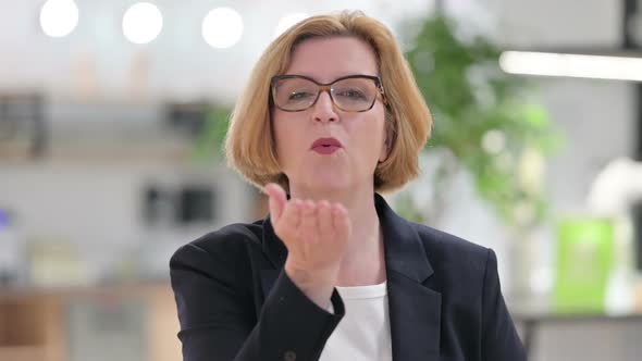 Portrait of Old Businesswoman Showing Heart Sign with Hand