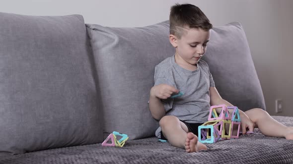 A little boy gaming with magnetic constructor. Creativity development. Magnetic constructor