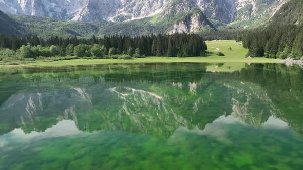 Emerald lake at Fusine with Mangart mountain