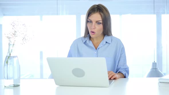 Video Chat on Laptop by Woman Sitting in Office for Work