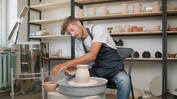 Pottery Workshop Man Ceramist Makes a Pitcher Out of Clay Handicraft Production of Handmade