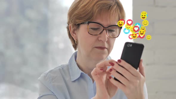 Old Woman Using Smartphone with Emojis, Smilies and Likes