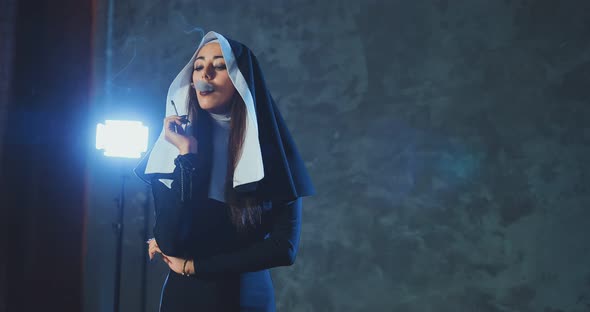 Beautiful Girl in the Image of a Nun with a Cigarette in Her Hand