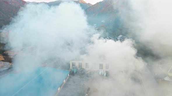 Aerial drone view of the moving steam train Mocanita at the railway station in Viseu de Sus, Romania