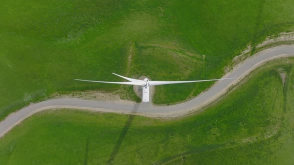 Cinematic Top Down Aerial Rotating Windmill Blades Generating Renewable Energy