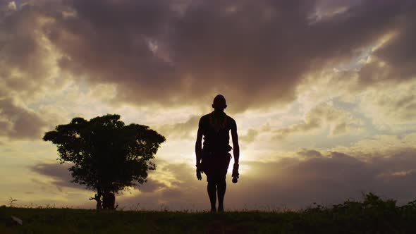 Man performing the Maasai jumping dance at sunet