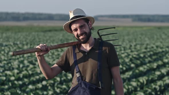 Farmer Posing with Pitchfork