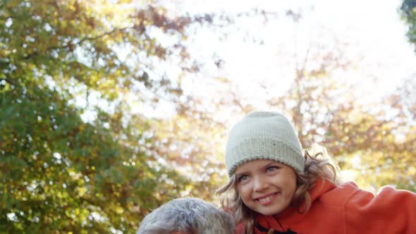 girl doing airplane with dad outdoors