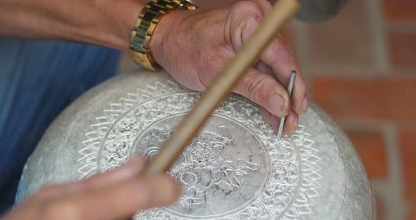 Hands Of Silversmith Using The Engraver To Engrave Art Tracery On Silverware