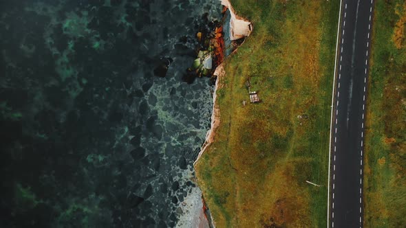 Top View Drone Flying Along Beautiful Autumn Bay Road Close To Ethereal Eroded Sandstone Sea Shore