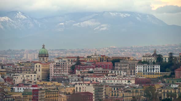 Panoramic View of Winter Naples with Snowy Mountains Background