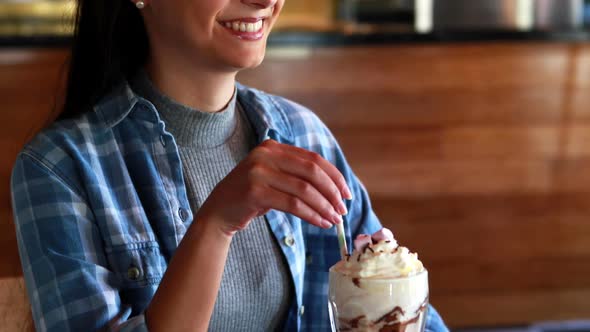 Happy woman drinking milkshake