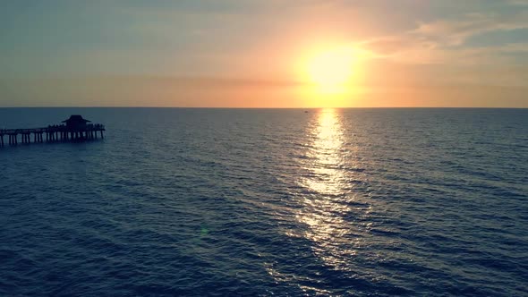 Silhouette of a Pier Over the Water at Sunset