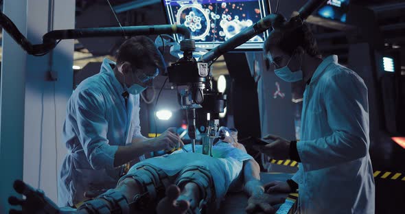 Young Scientists Surgeons Conduct Scientific Experience on the Alien