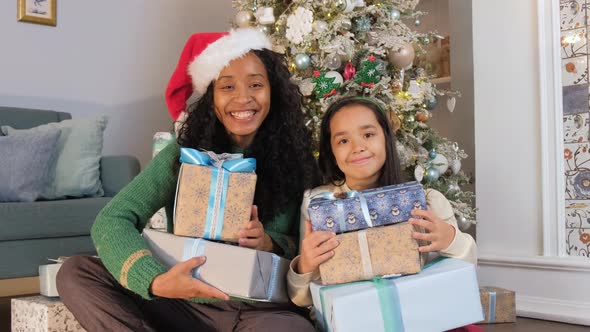 Mother and Daughter Hold Presents in Christmas Atmosphere