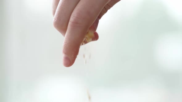 Close Up of Female Hand Breaking Shortbread Cookie