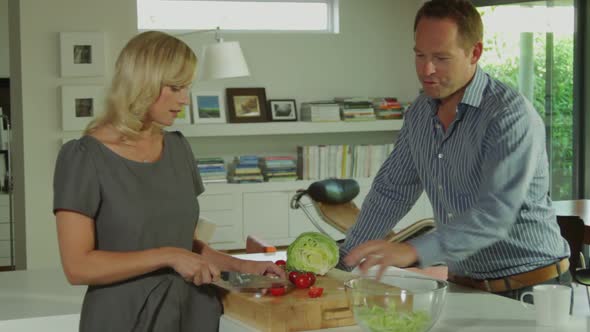 Wide shot off couple in ktichen preparing a healthy salad