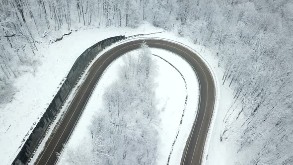 Drones Eye View  Winding Road From the High Mountain Pass in Winter