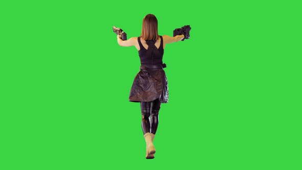 Gamecharacter Girl Walks with Machine Guns Shooting with Both Hands on a Green Screen Chroma Key