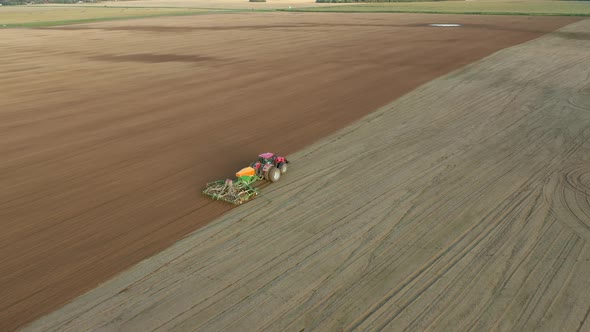 Farmer In Tractor Planting Seeds Of Corn Crops In Agricultural Field Aerial View