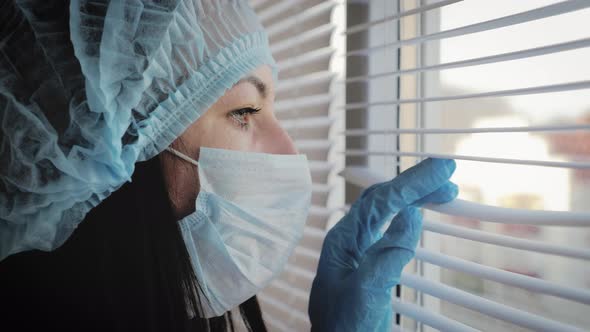 Tired Look of a Health Worker Wearing a Surgical Mask During a Break