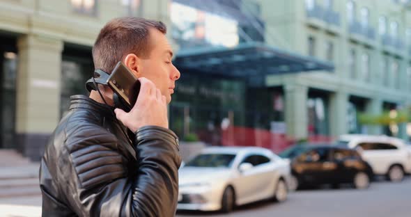 Man Wearing Headphones in a City