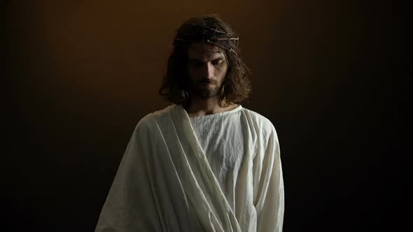 Jesus in Crown of Thorns Looking to Camera, Punishment for Mortal People Sins