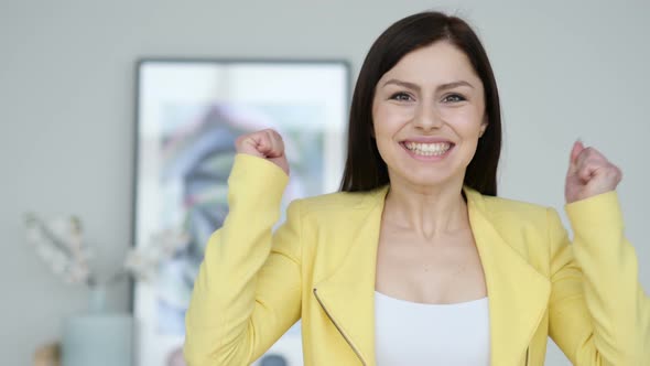 Young Woman Celebrating Success  Gesture in Office