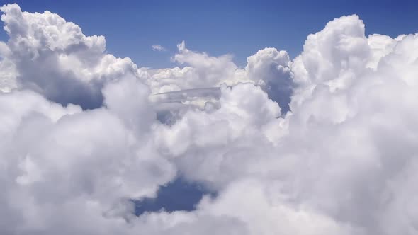 View from airplane window flying through the clouds