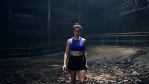 4K Portrait of Asian woman boxer practicing boxing exercise in abandoned building.