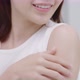 Close up shot Beautiful Asian woman applying moisturizer cream on her shoulder and arm gently. - VideoHive Item for Sale