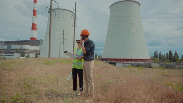 Electrical Engineer In Helmet Power Line. Constructor Checking High Voltage Sensor Power Line Wire.