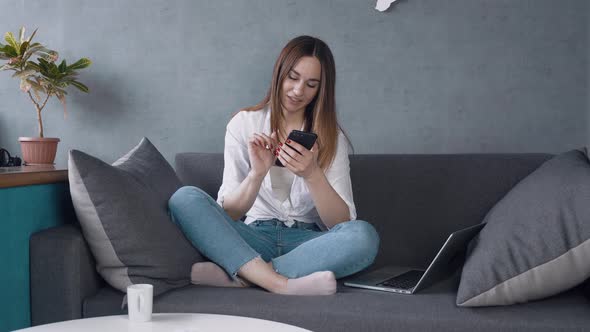 Young Woman Using Smart Phone Surfing Social Media Checking News Playing Mobile Games or Texting