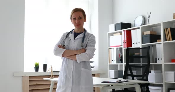 Doctor in White Coat with Arms Crossed Looking Into Camera