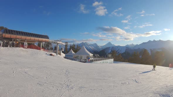 Winter Mountains Panorama with Ski Slopes and Ski Lifts on a Sunny Day