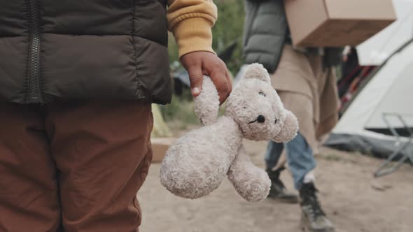 Old Stuffed Toy in Hand of Refugee Girl