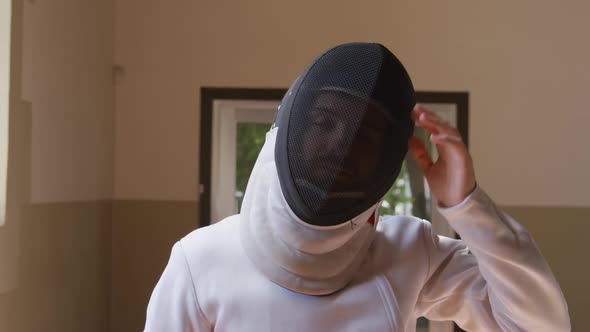 Fencer athlete during a fencing training in a gym