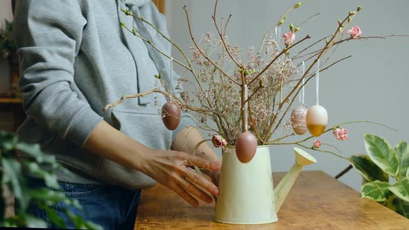 Woman Decorating DIY Easter Floral Arrangement