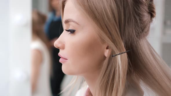 Close Up Face of Adorable Young Model with Makeup During Creating Hairstyle